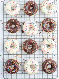 frosted cake batter donuts on a cooling rack