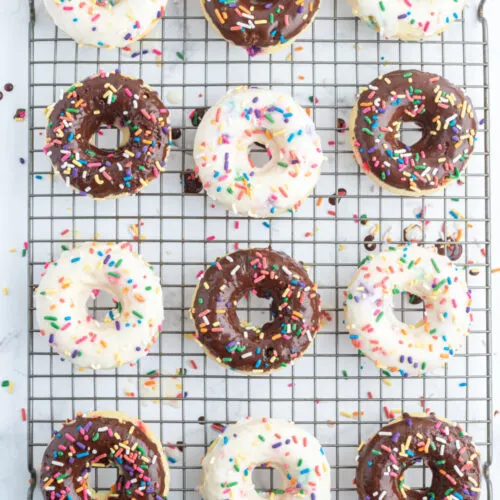 frosted cake batter donuts on a cooling rack