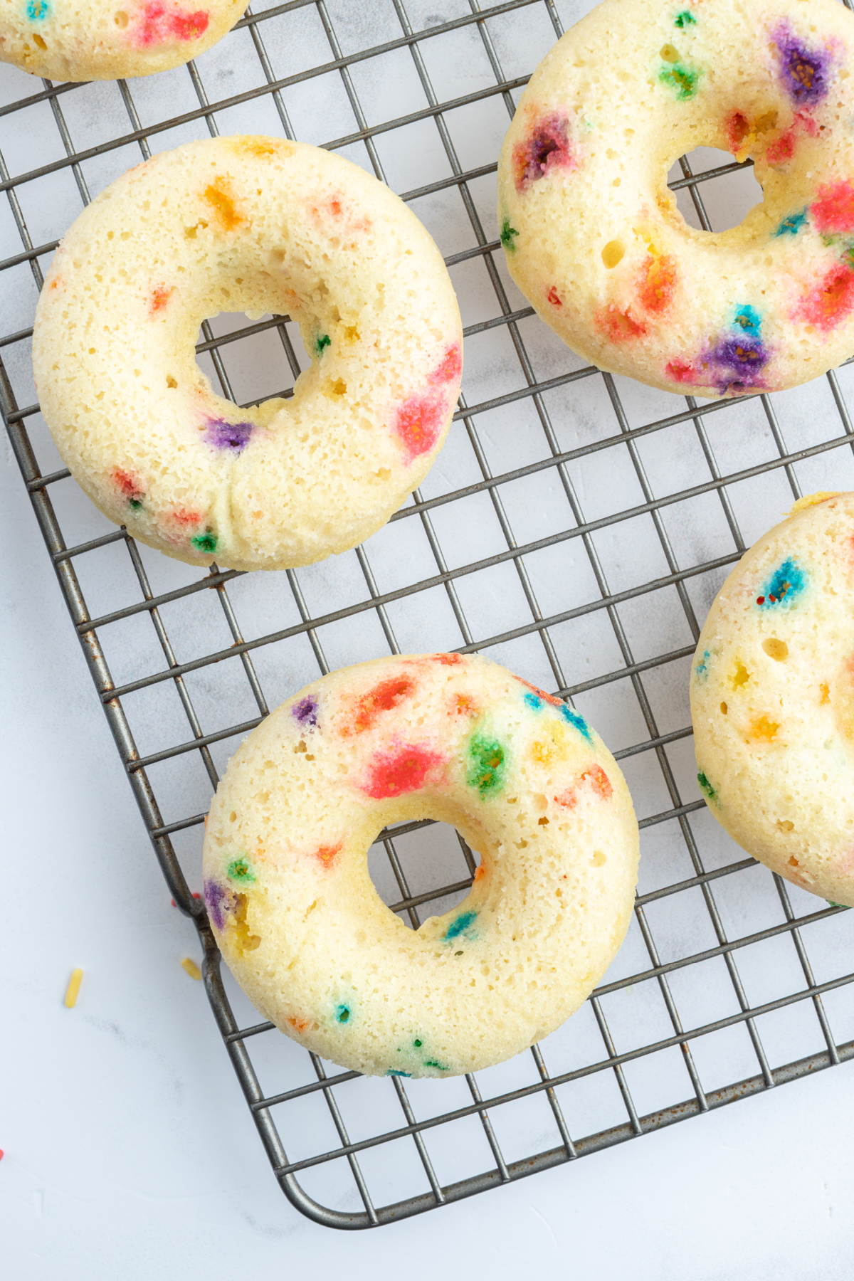 unfrosted cake mix donuts on a cooling rack