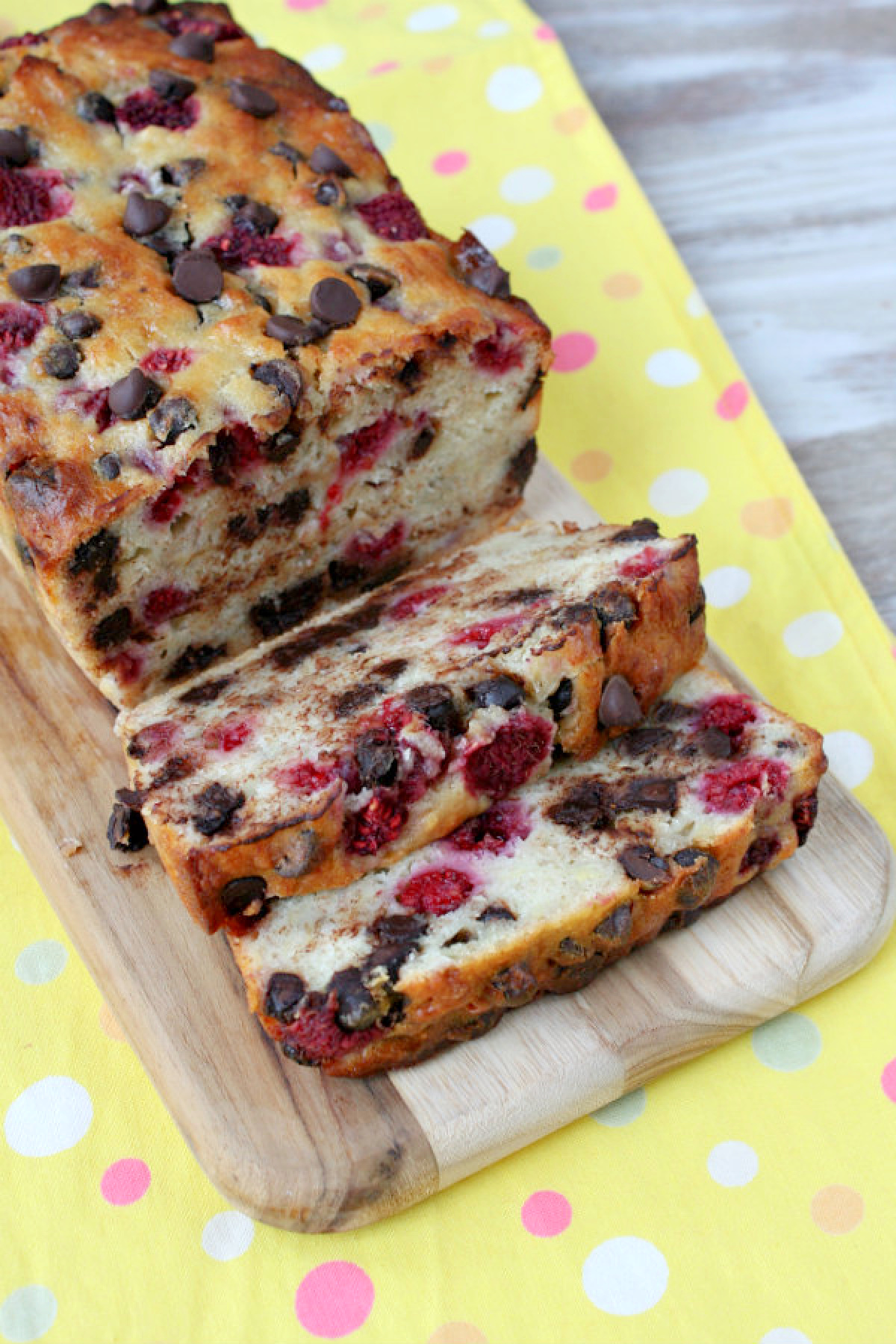 loaf of raspberry dark chocolate banana bread on board and sliced