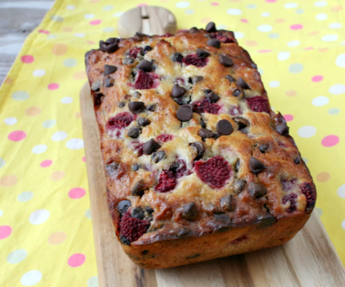 loaf of raspberry dark chocolate banana bread on yellow cloth