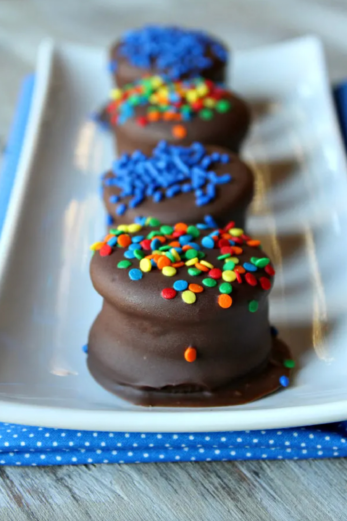chocolate dipped peanut butter stuffed oreos on a platter