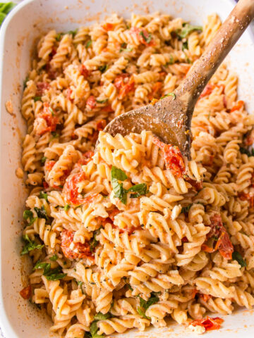 casserole dish of tik tok baked feta pasta with wooden spoon