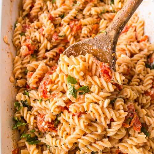 casserole dish of tik tok baked feta pasta with wooden spoon