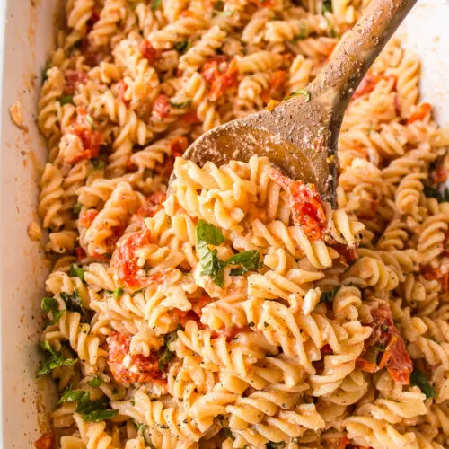 casserole dish of tik tok baked feta pasta with wooden spoon