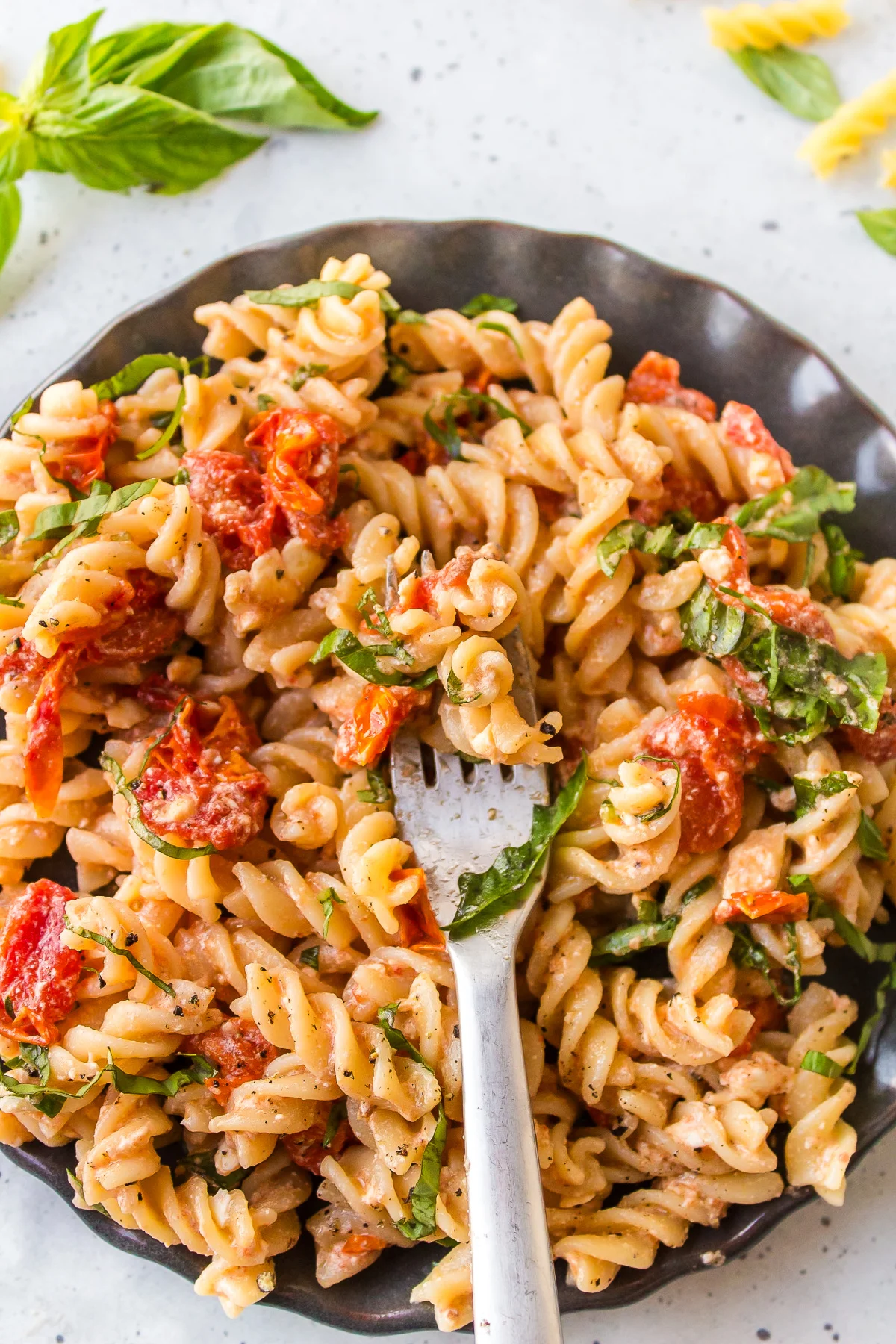 tik tok baked feta pasta serving on plate with fork