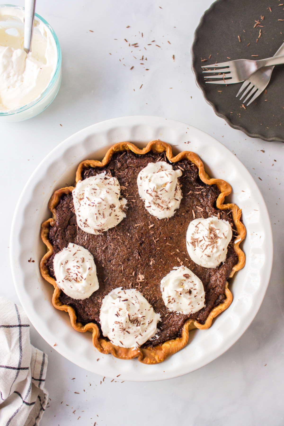 chocolate chess pie with dollops of whipped cream on top