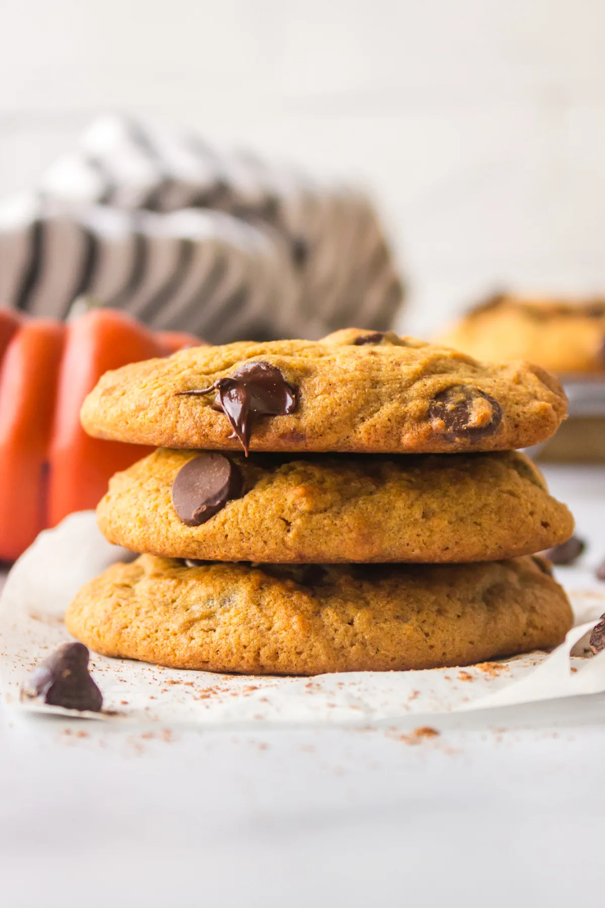 stack of three pumpkin chocolate chip cookies