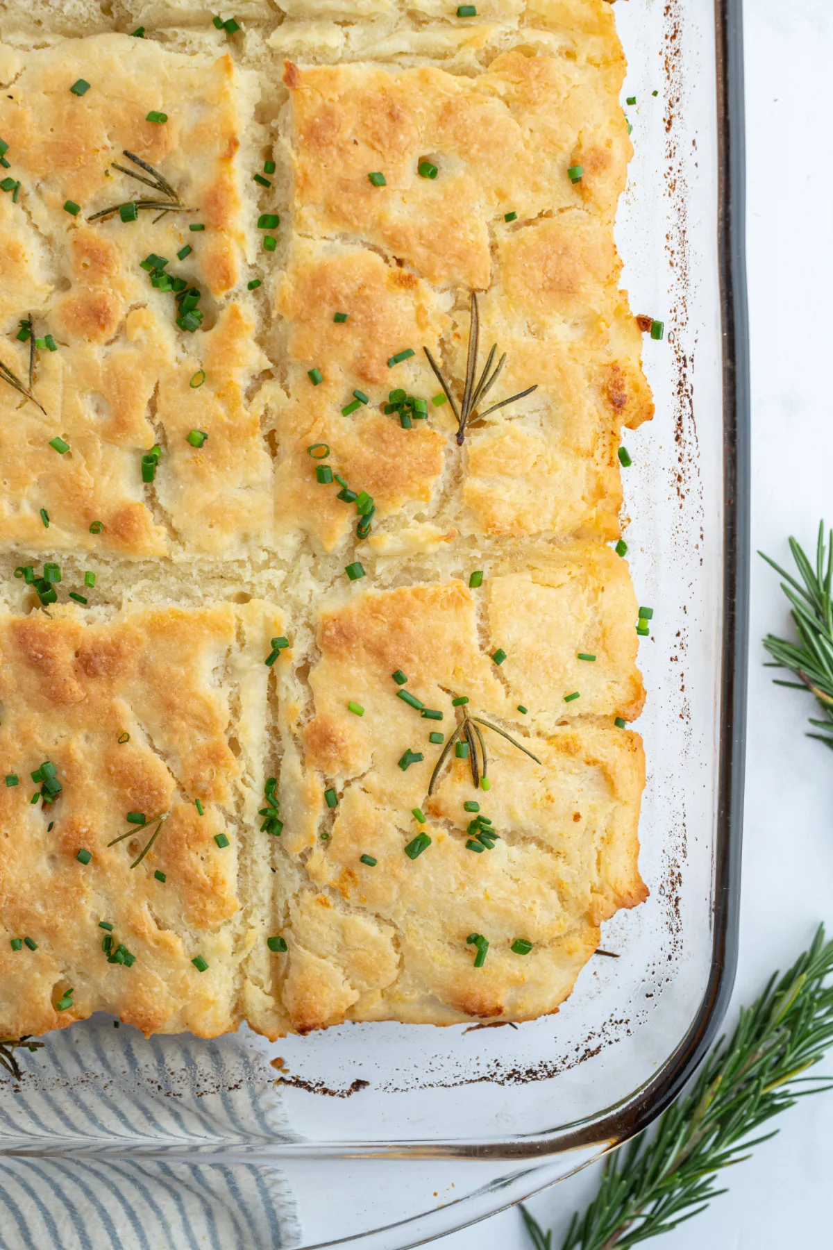 corner shot of a pan of rosemary garlic butter bath biscuits
