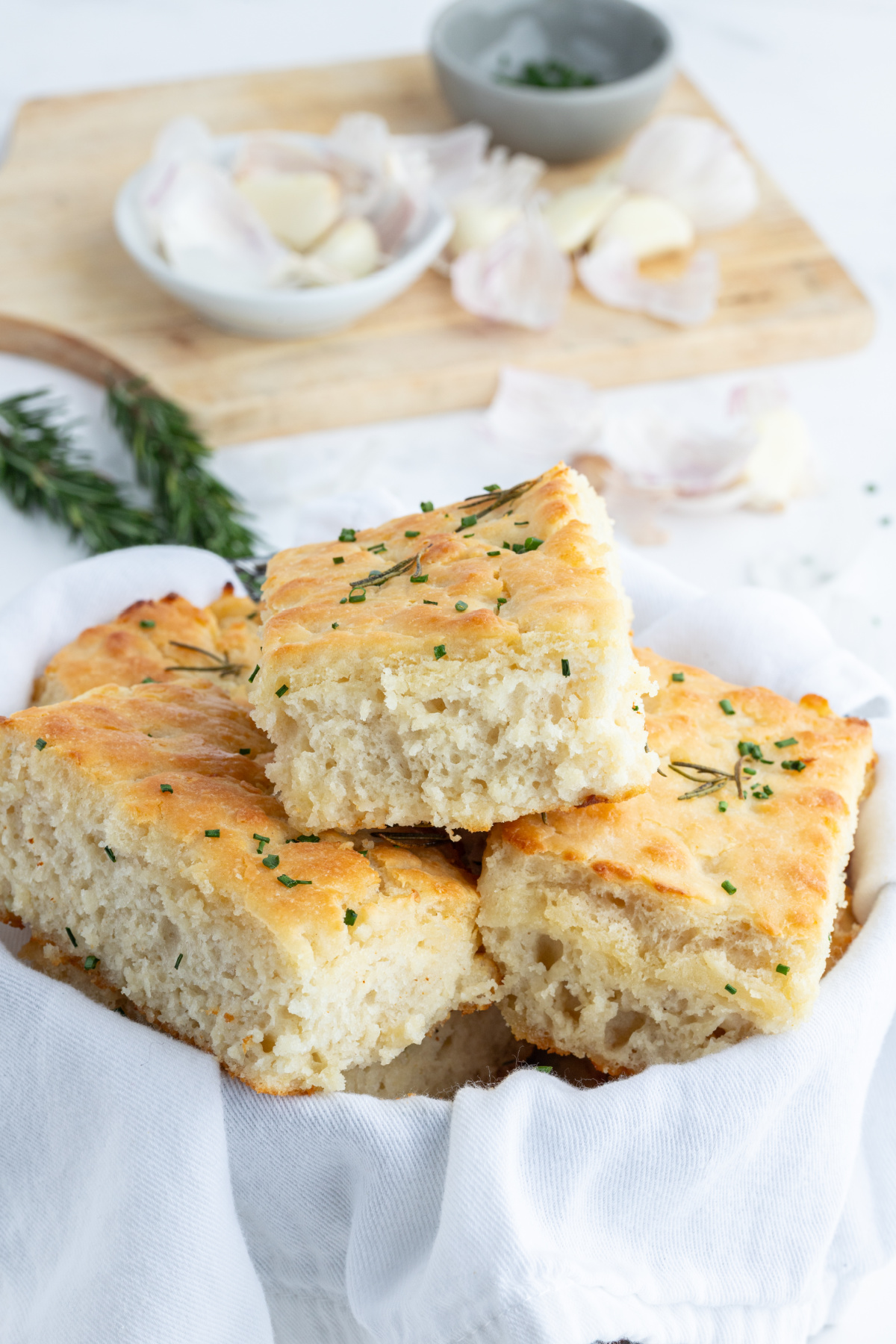 rosemary garlic butter bath biscuits in serving dish lined with cloth