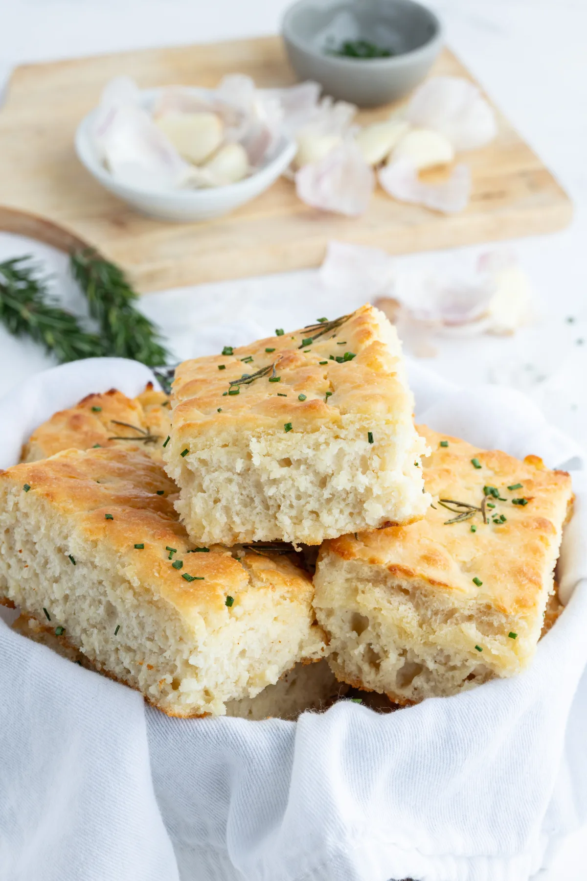 rosemary garlic butter bath biscuits in serving dish lined with cloth