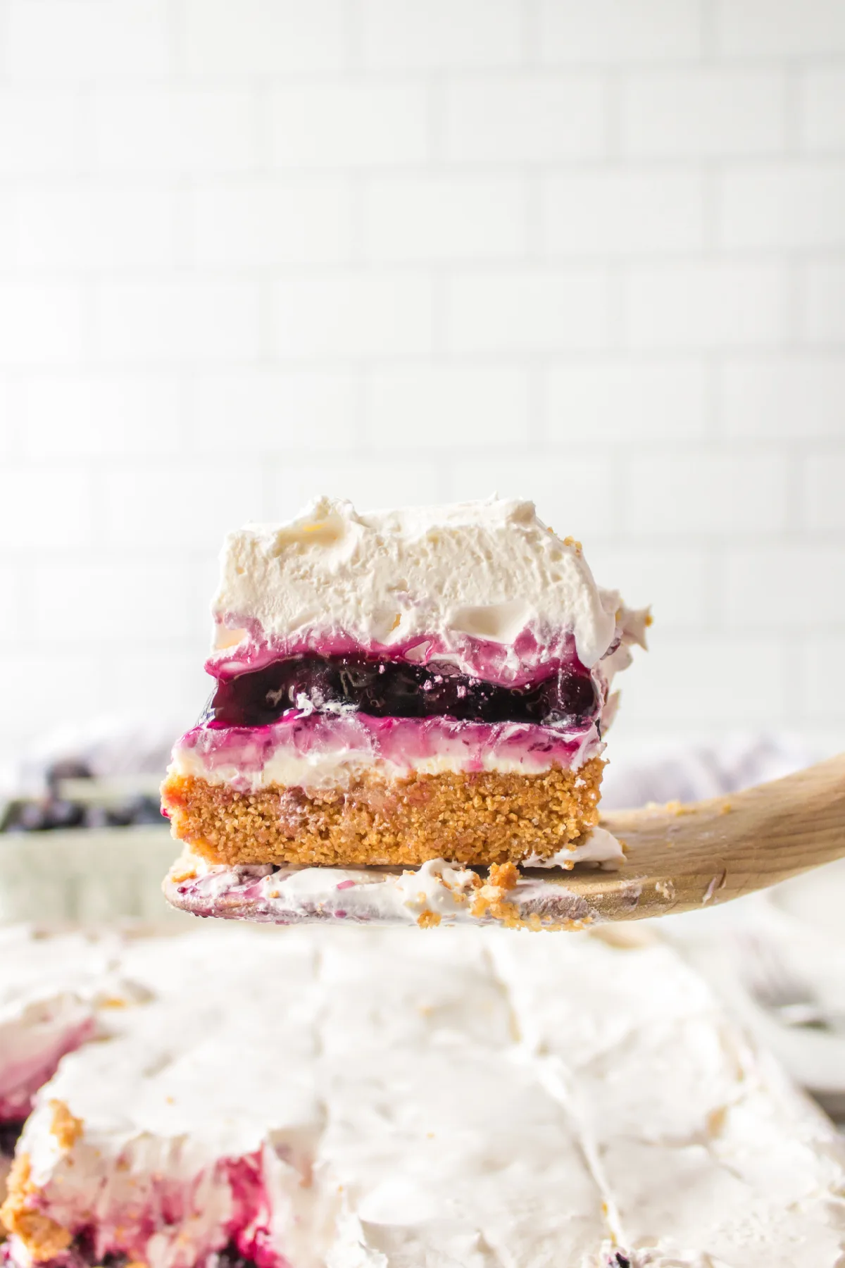 spatula taking blueberry cream cheese square out of pan