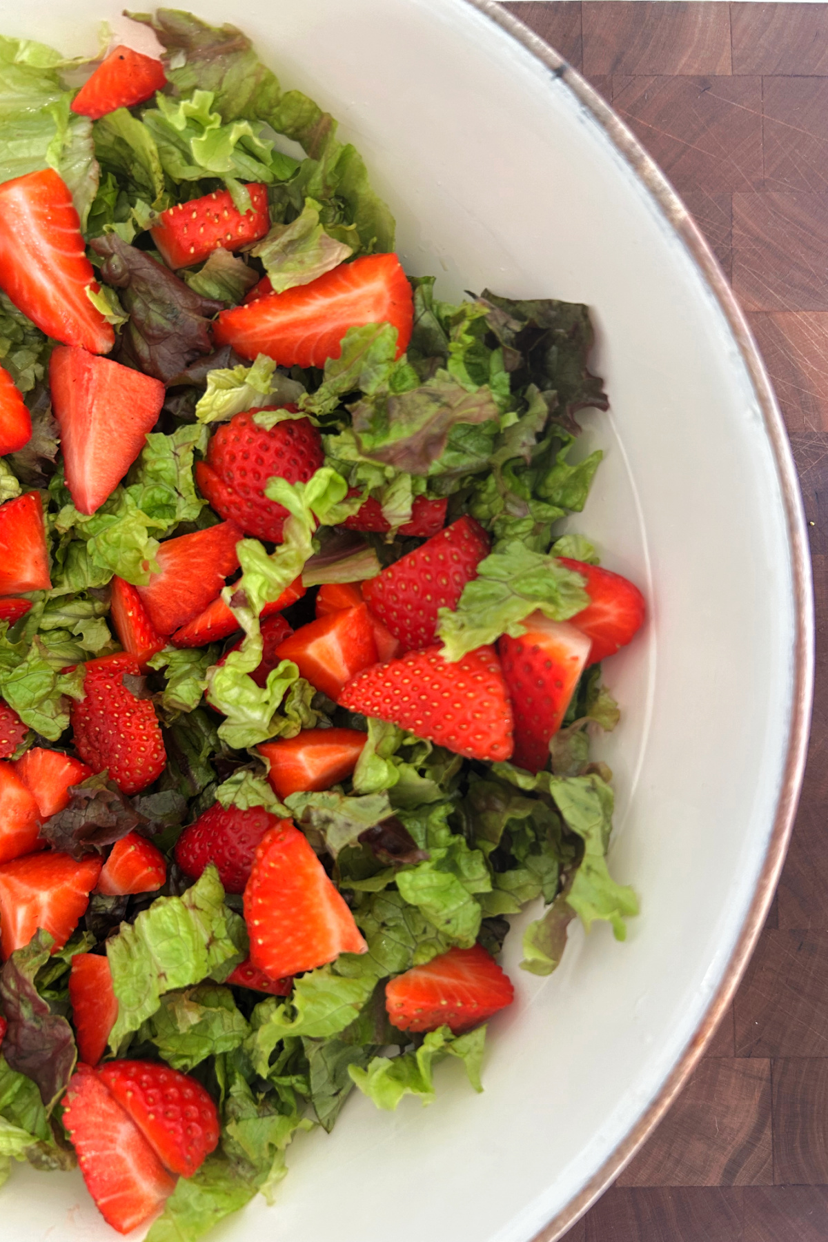 lettuce with strawberries in bowl