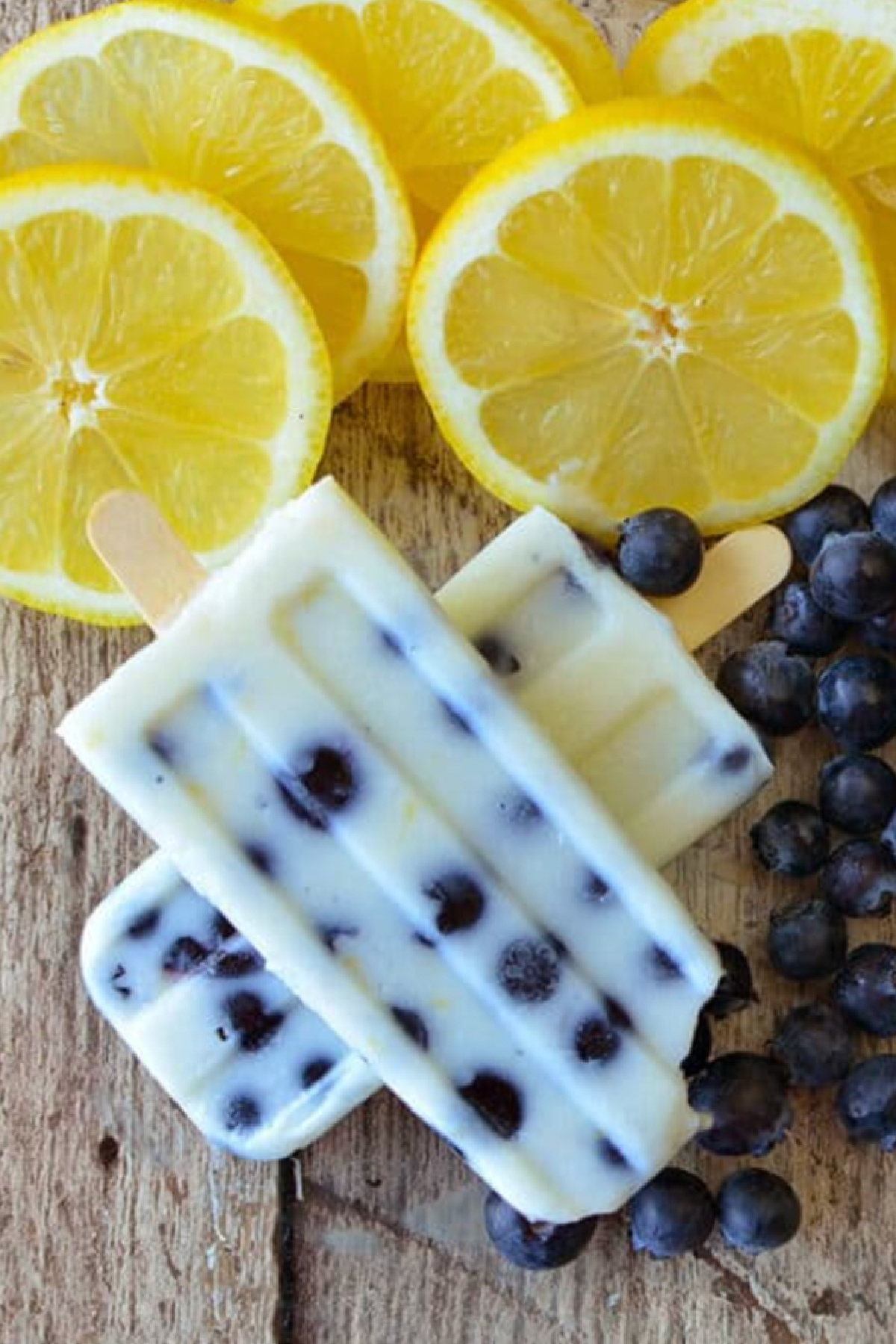 two stacked blueberry lemon pudding pops with lemon slices
