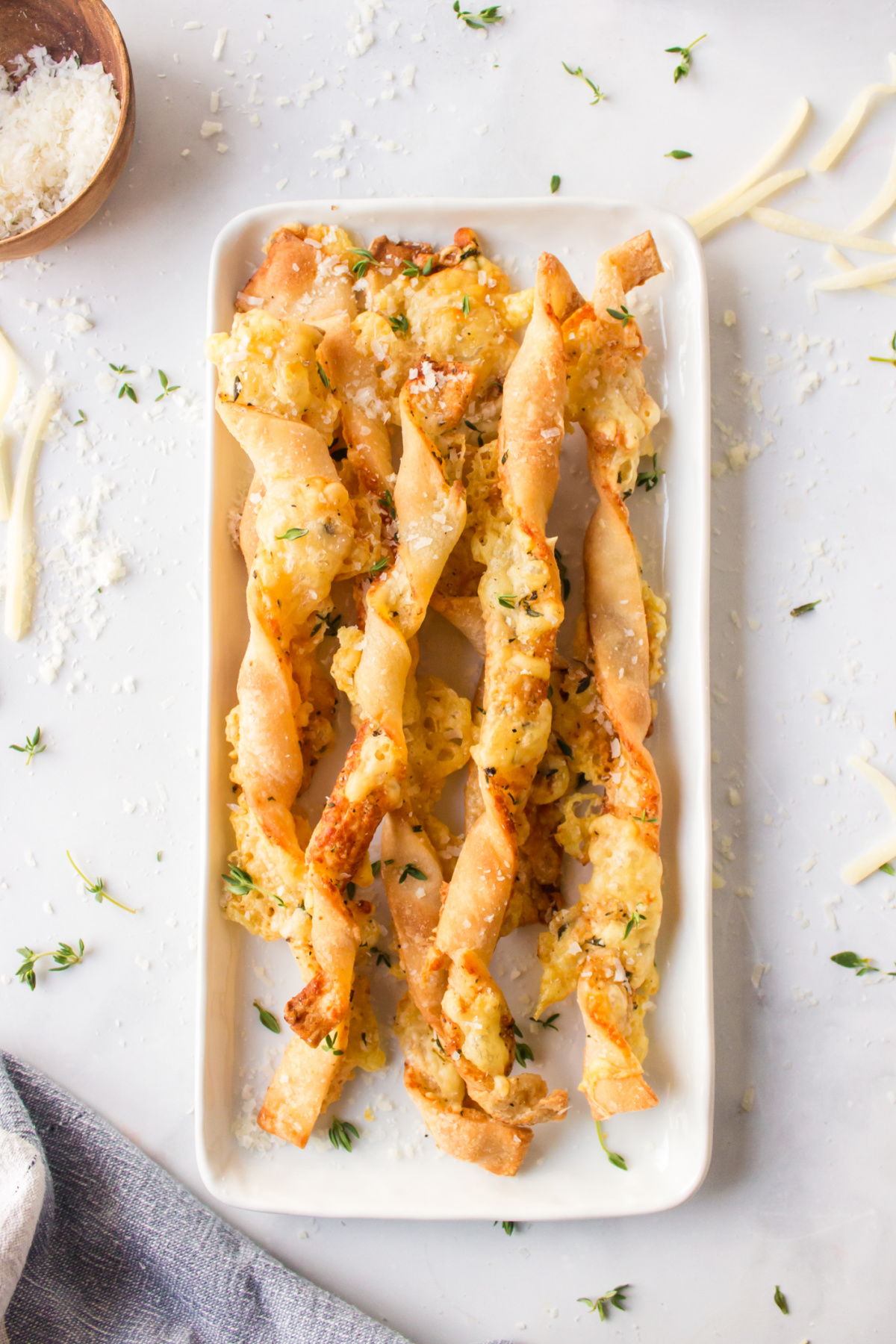 cheese straws displayed on white dish