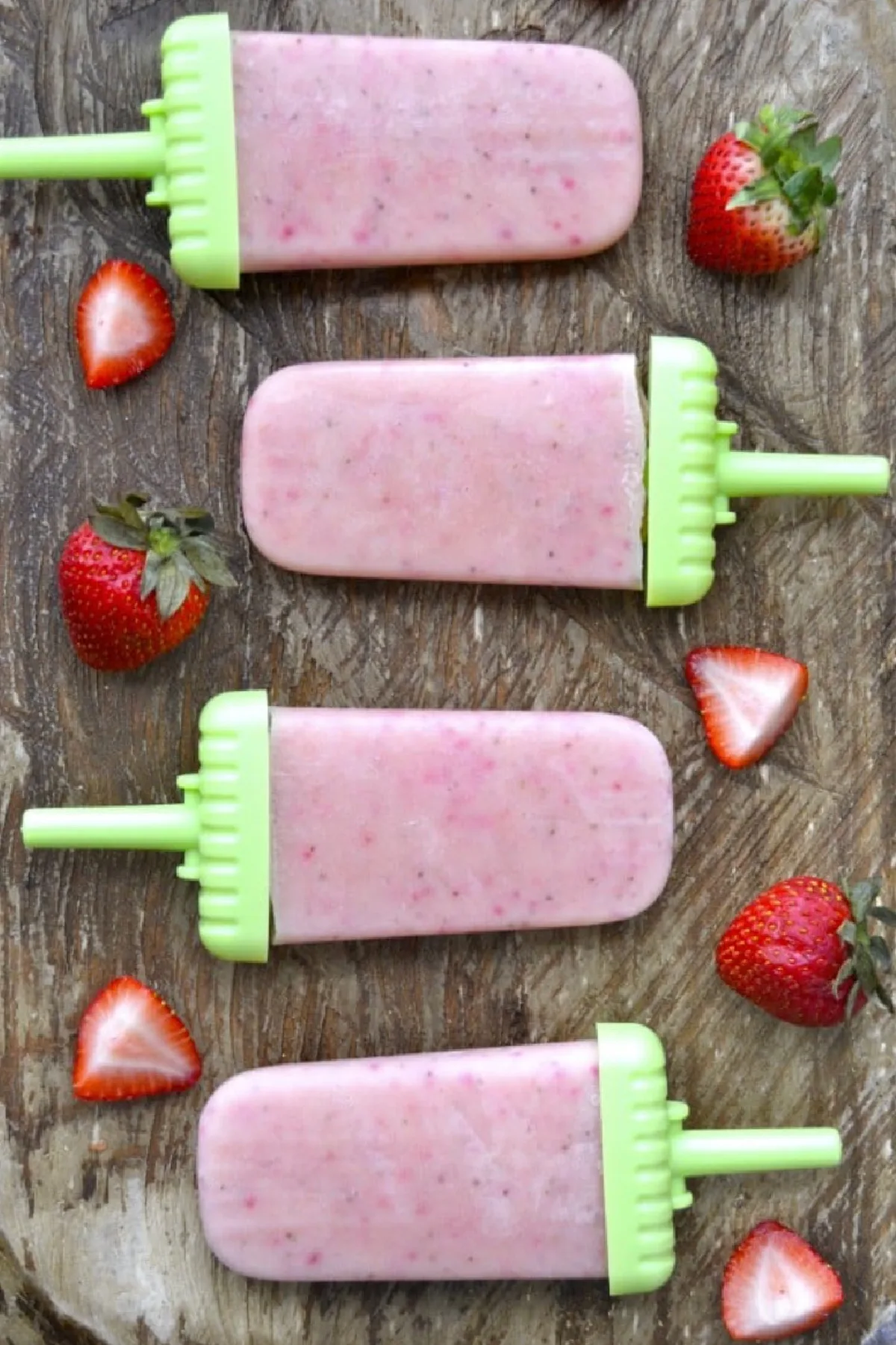 fresh strawberry and vanilla pudding pops laid on table