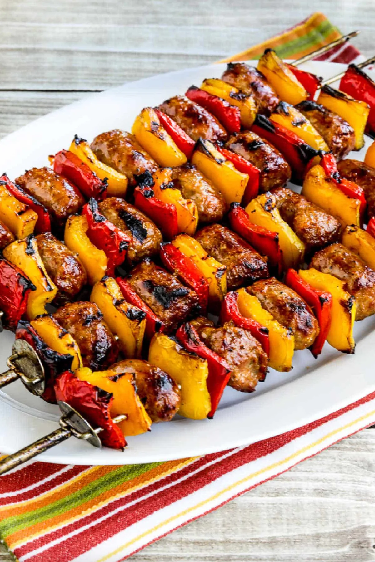 grilled sausage and peppers kebabs on platter