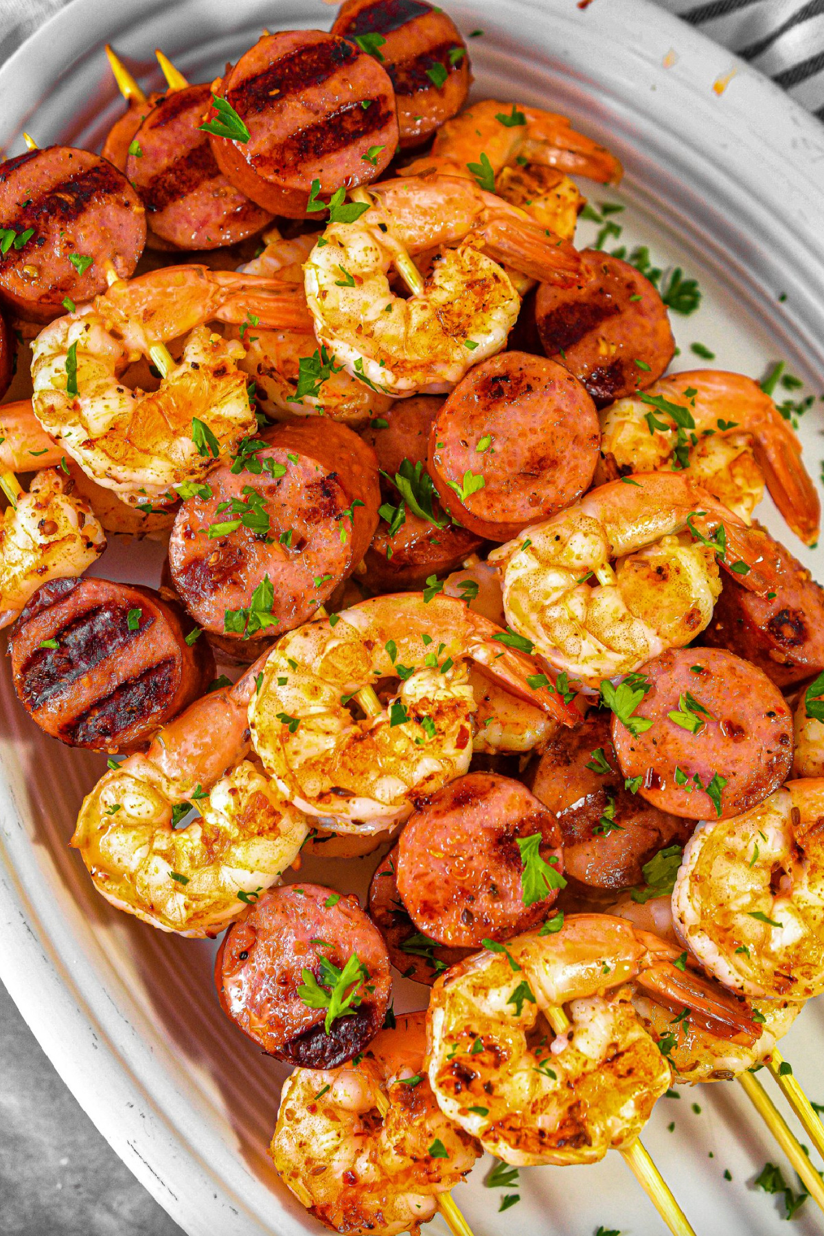 sausage and shrimp kebabs on a platter