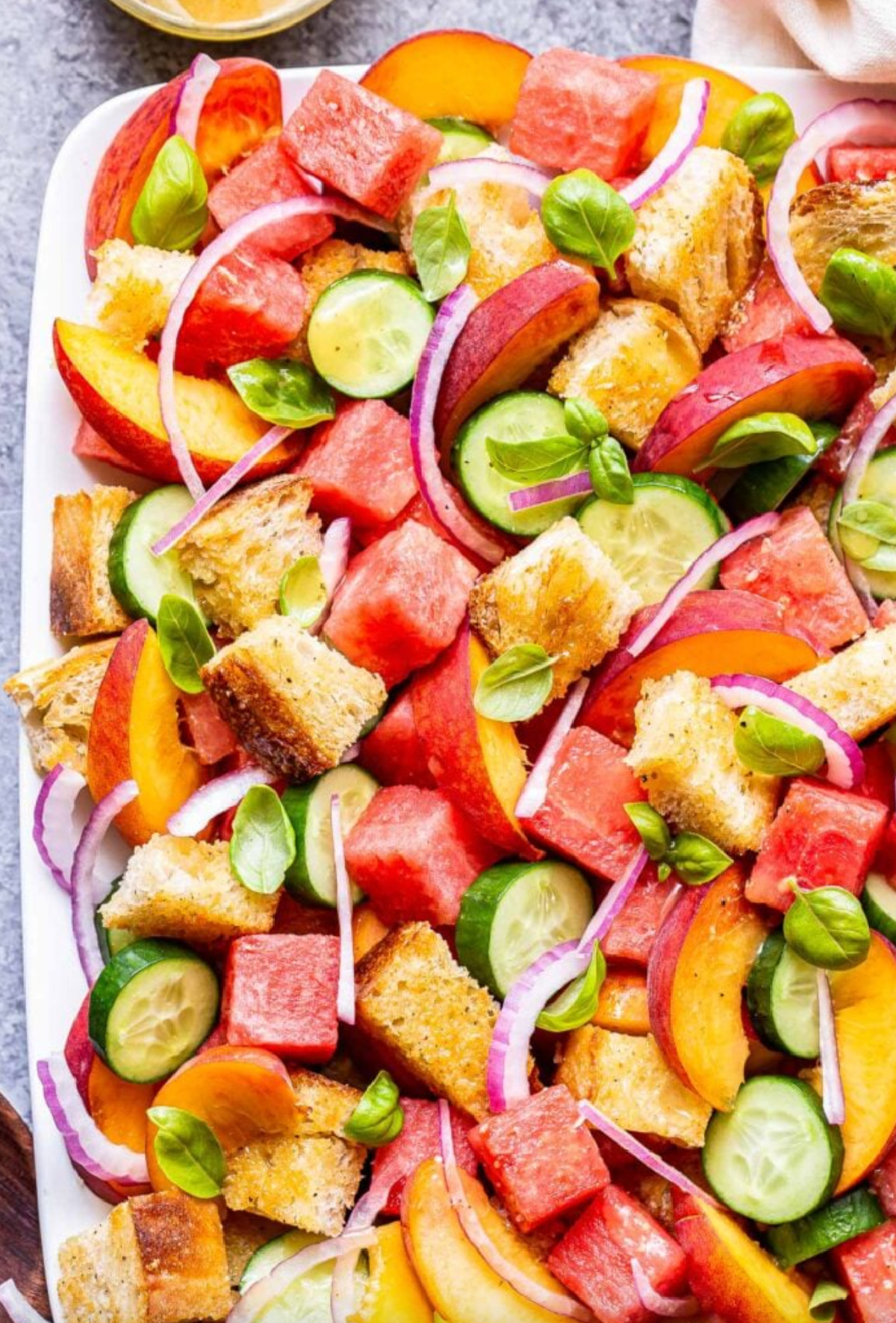 watermelon peach panzanella salad on platter