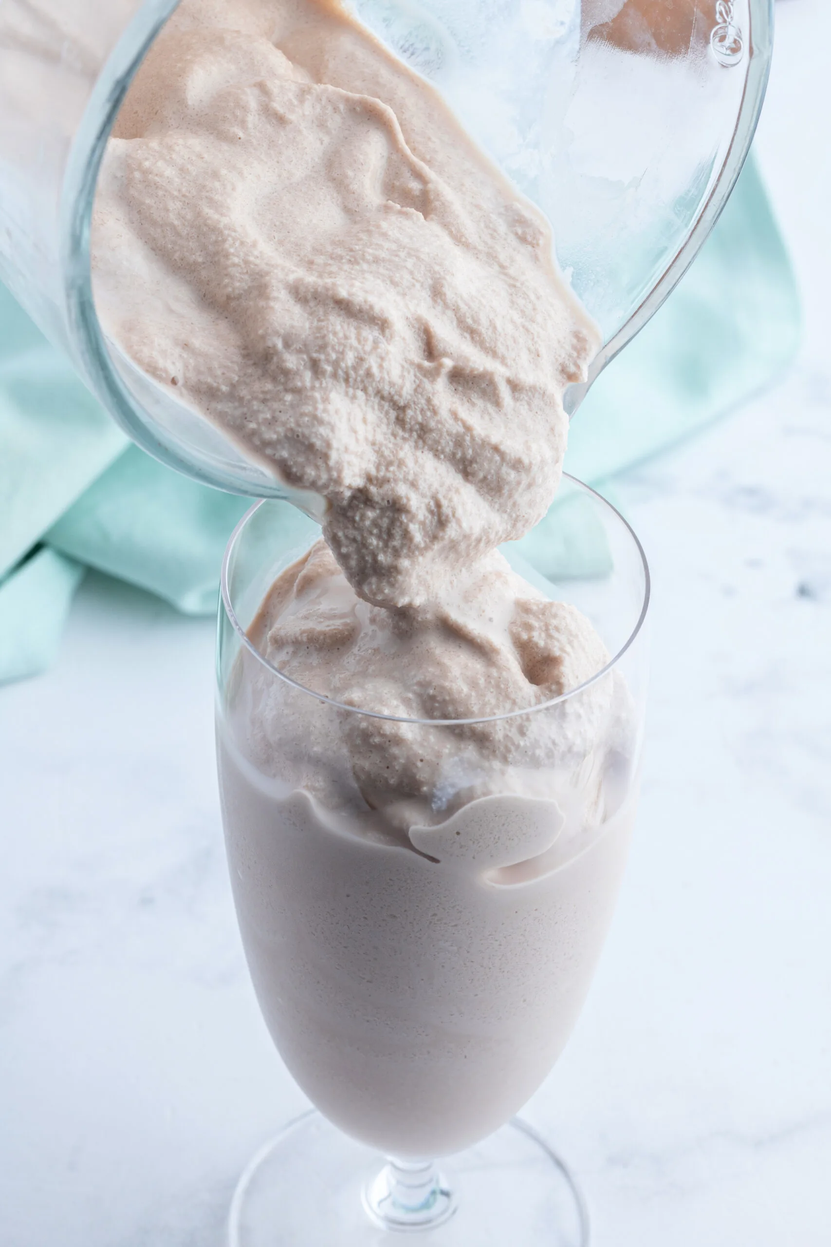 pouring chocolate frosty into glass