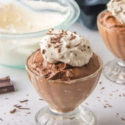 glass of chocolate mousse with whipped cream on top