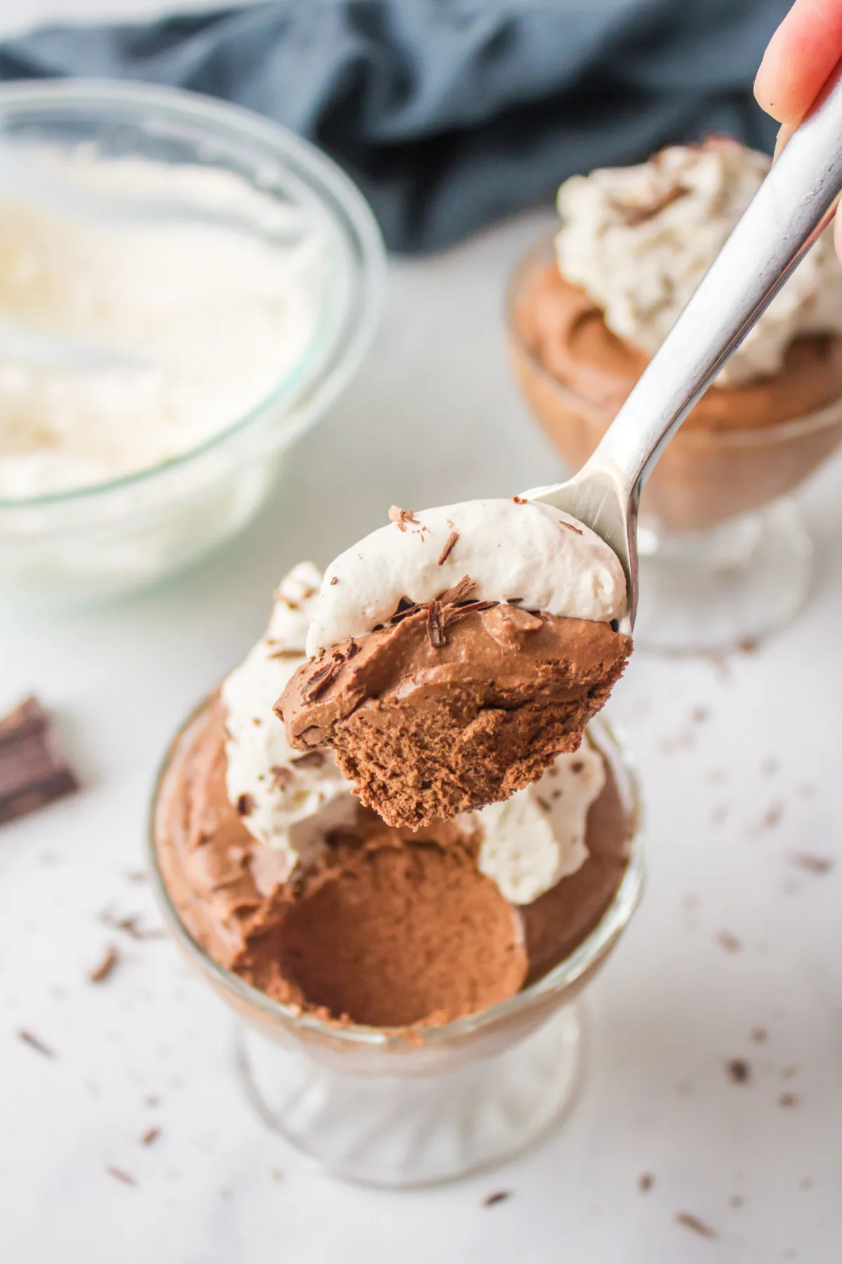 spooning chocolate mousse out of glass