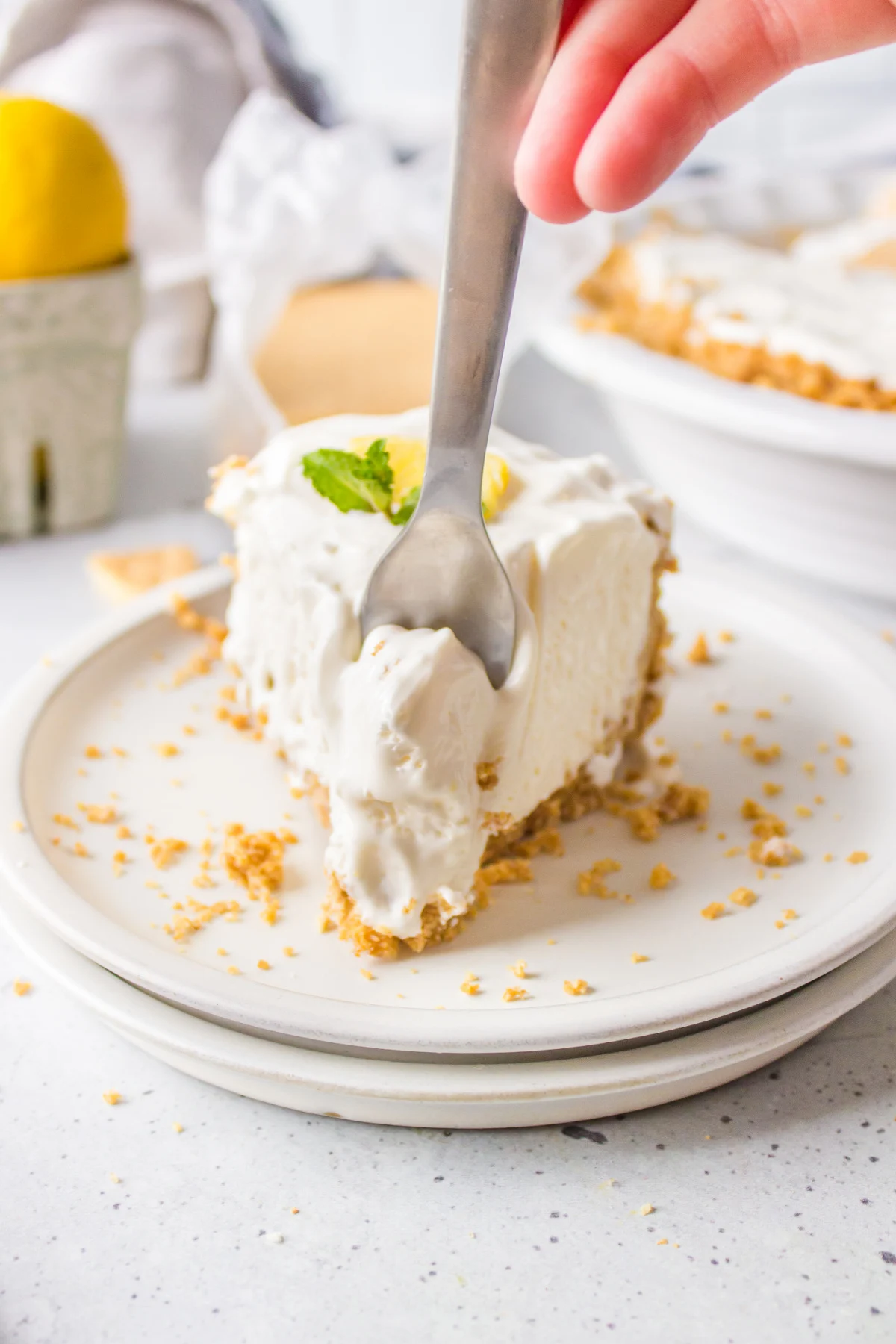 fork in slice of easy lemon pie on plate