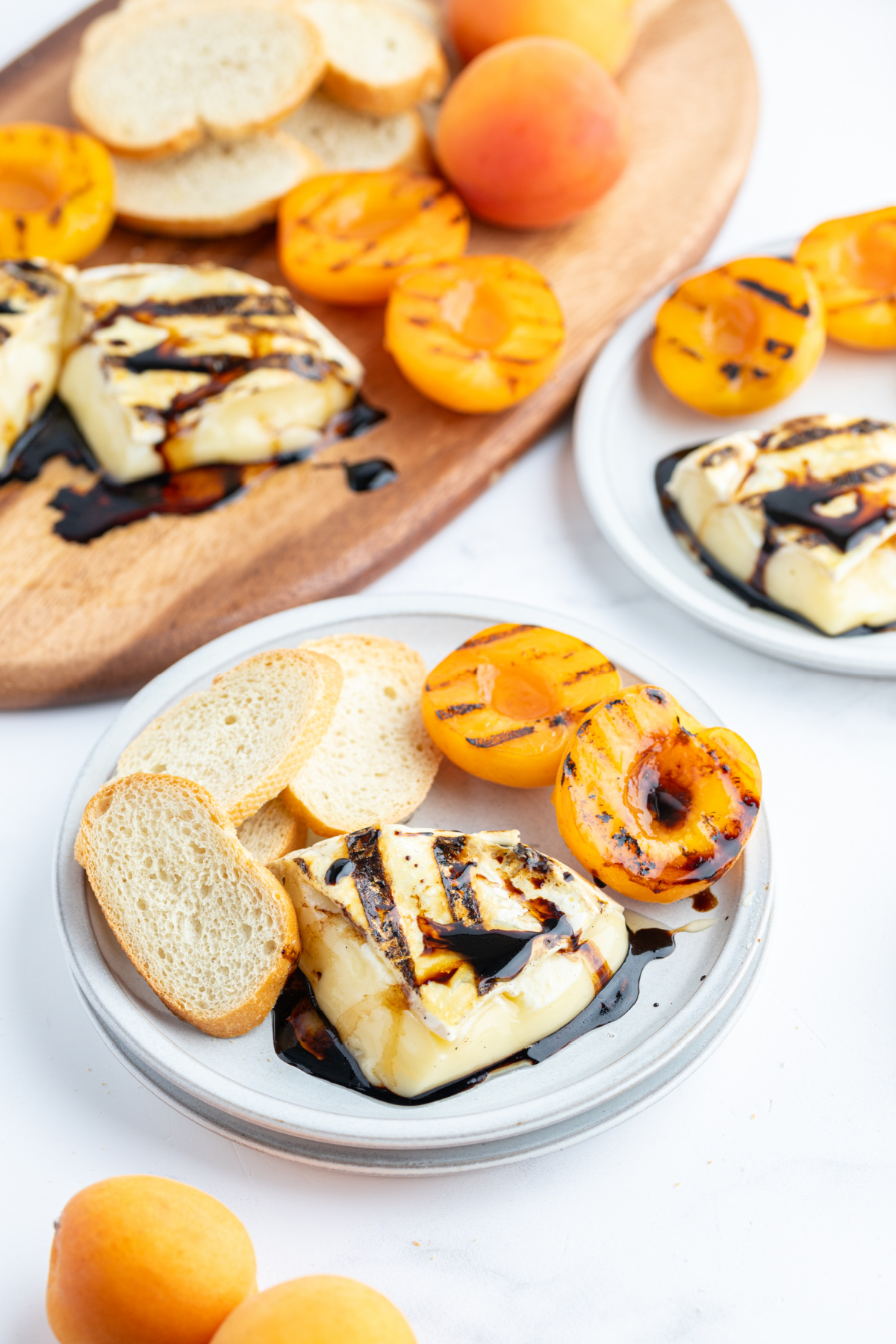 baguette slices on plate with melted brie and apricot