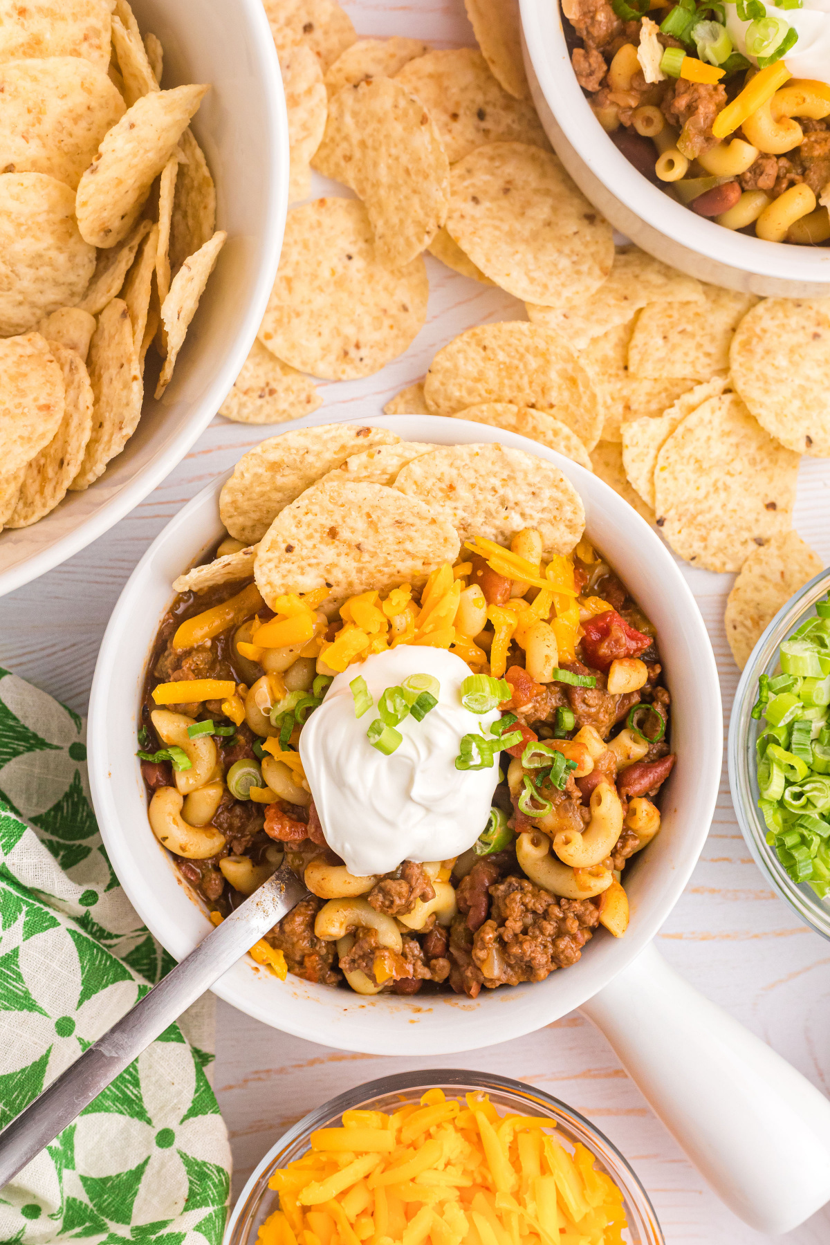 beef chili mac in bowl with sour cream