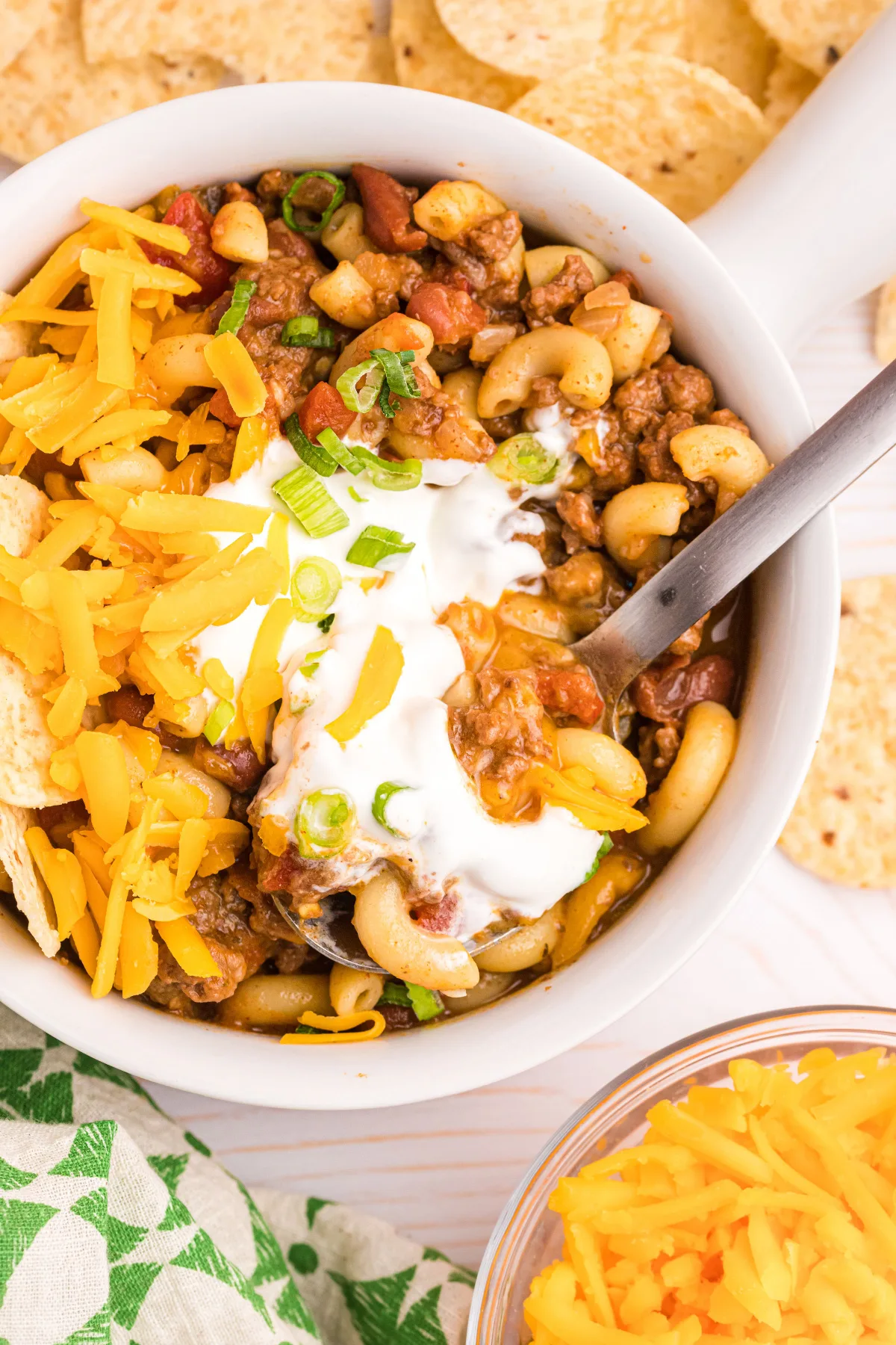 overhead shot of bowl of beef chili mac with sour cream