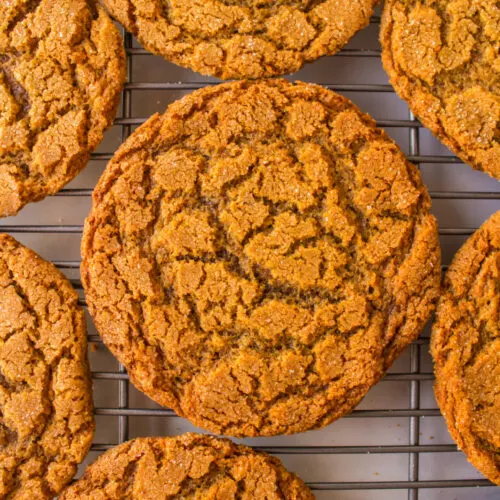 crackle top molasses cookies on a cooling rack