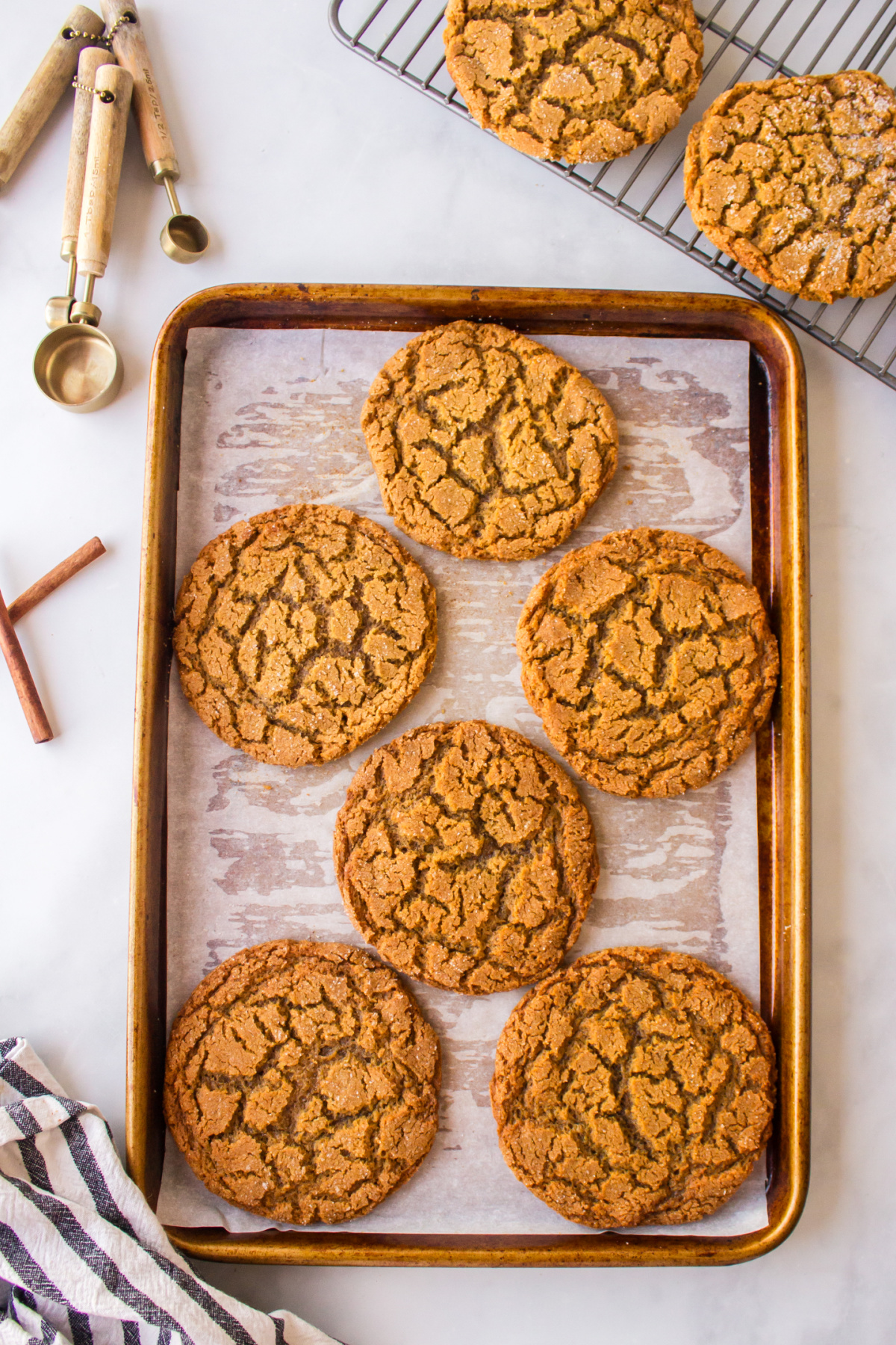 crackle top molasses cookies cooling on baking sheet