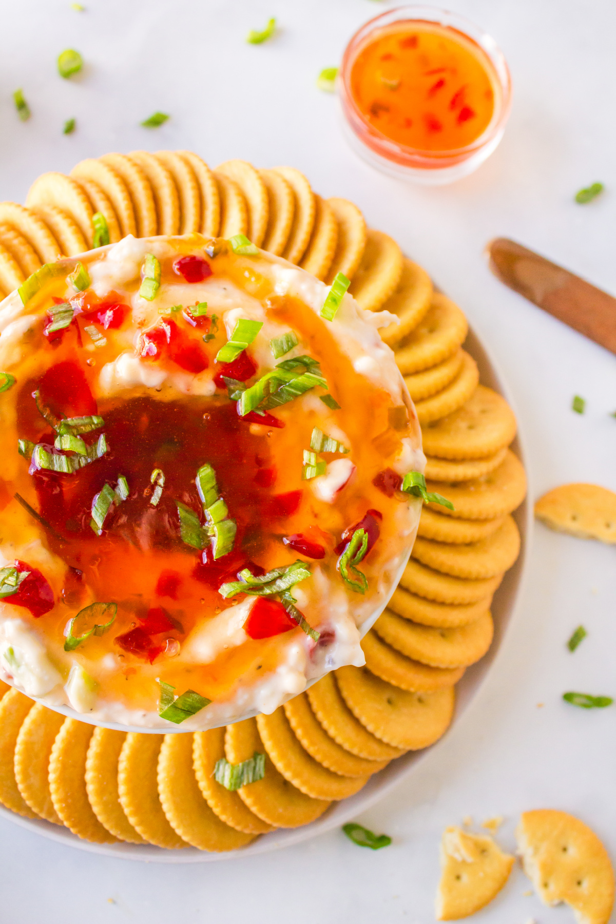 pepper jelly cream cheese dip surrounded by crackers