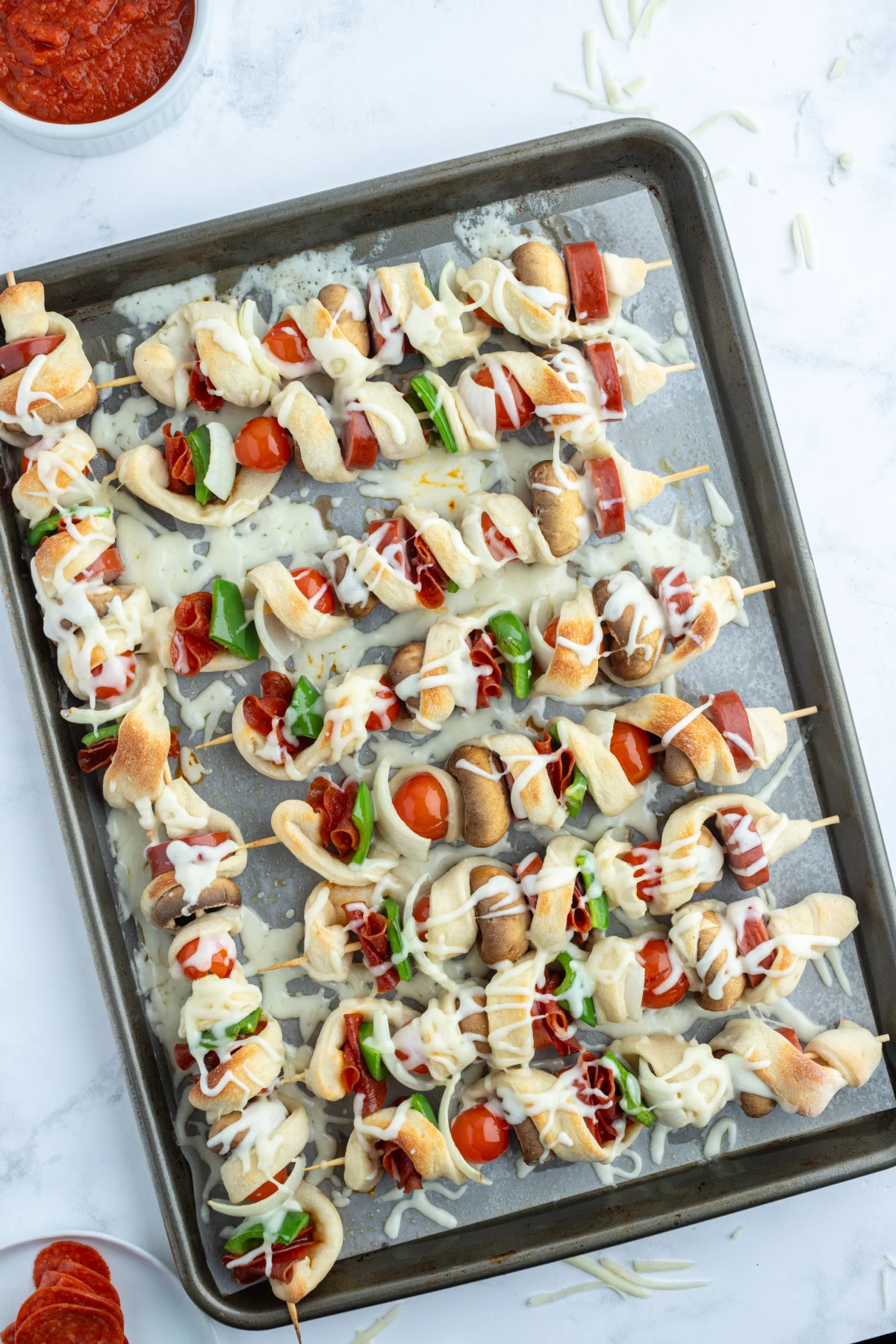 pizza kabobs on baking sheet