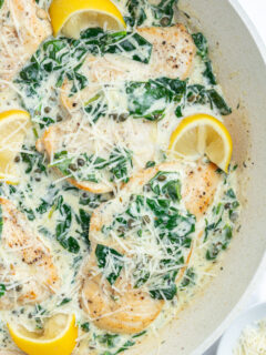 Mediterranean chicken skillet with lemon wedges