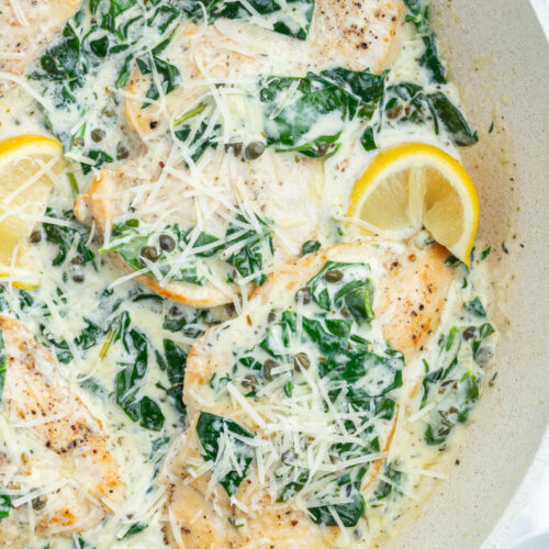 Mediterranean chicken skillet with lemon wedges