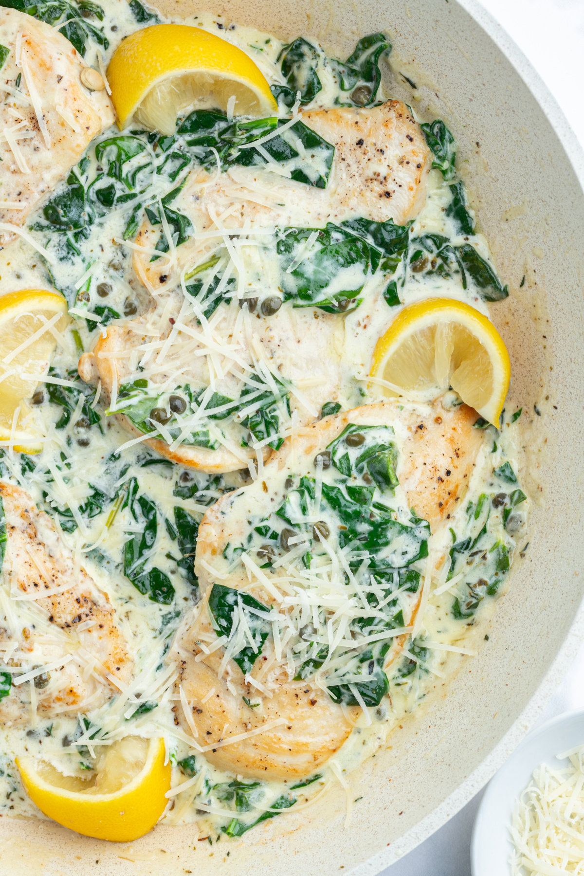 Mediterranean chicken skillet with lemon wedges